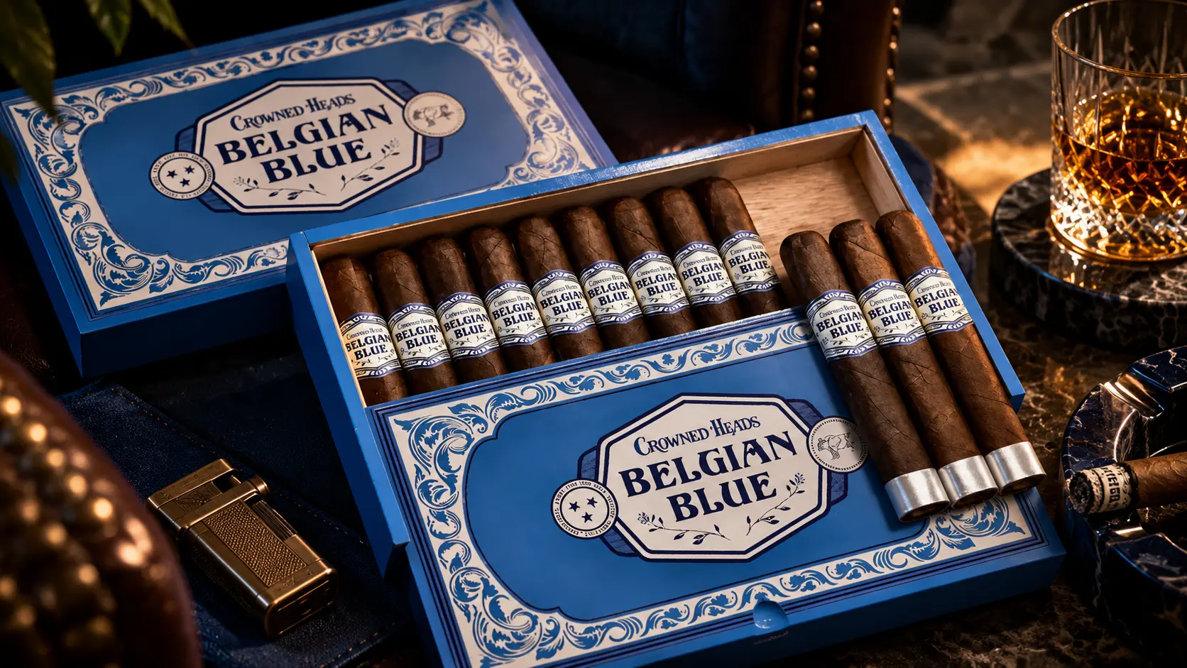 Two open boxes of Crowned Heads Belgian Blue cigars on a dark table, with a lighter and a glass of whisky