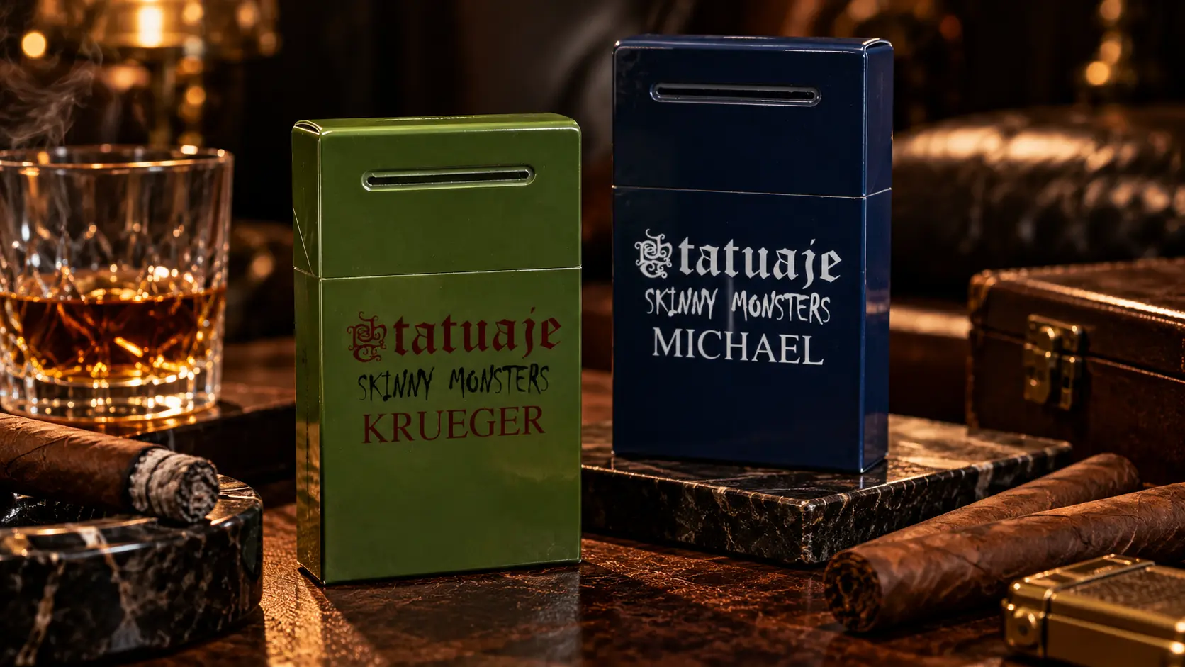 Green Tatuaje Skinny Monsters Krueger box and blue Skinny Michael box on a table with cigars and a glass of whisky